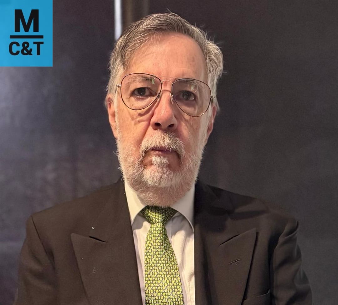 Man in suit with glasses and tie.